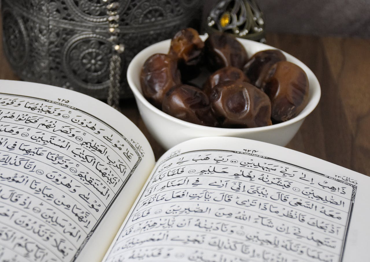 An open Quran with a bowl of dates, symbolizing Ramadan and Islamic traditions.